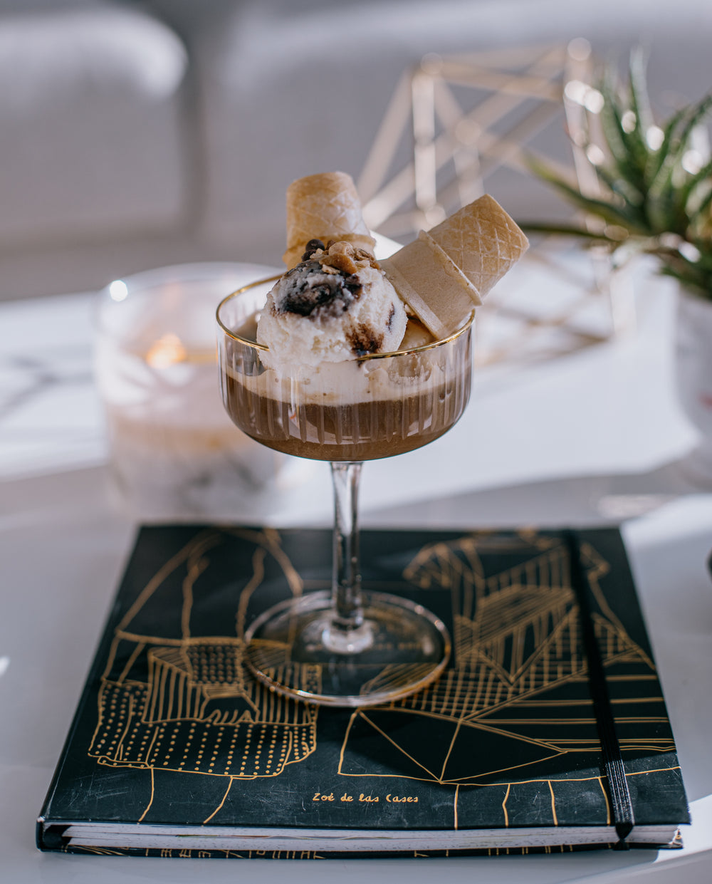 two ice cream cones upside down in a tall glass