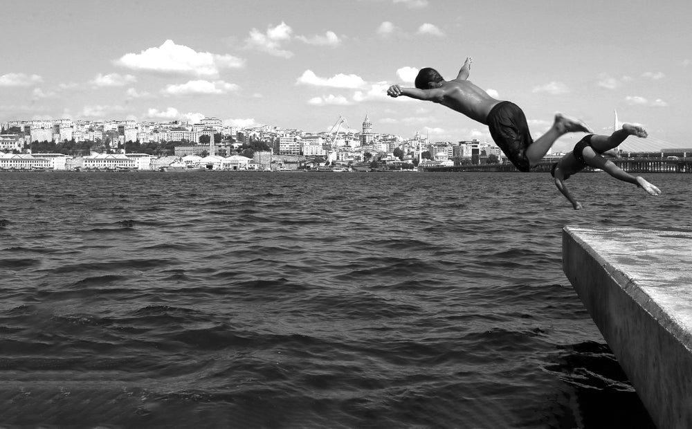 two people diving into the water