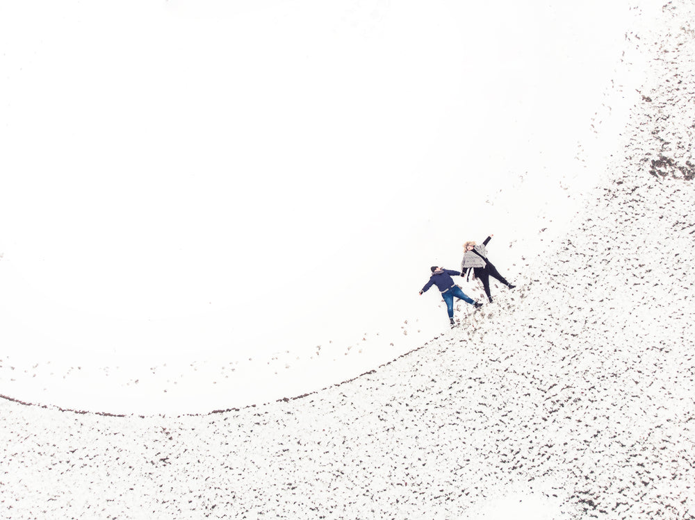 two women making snow angels