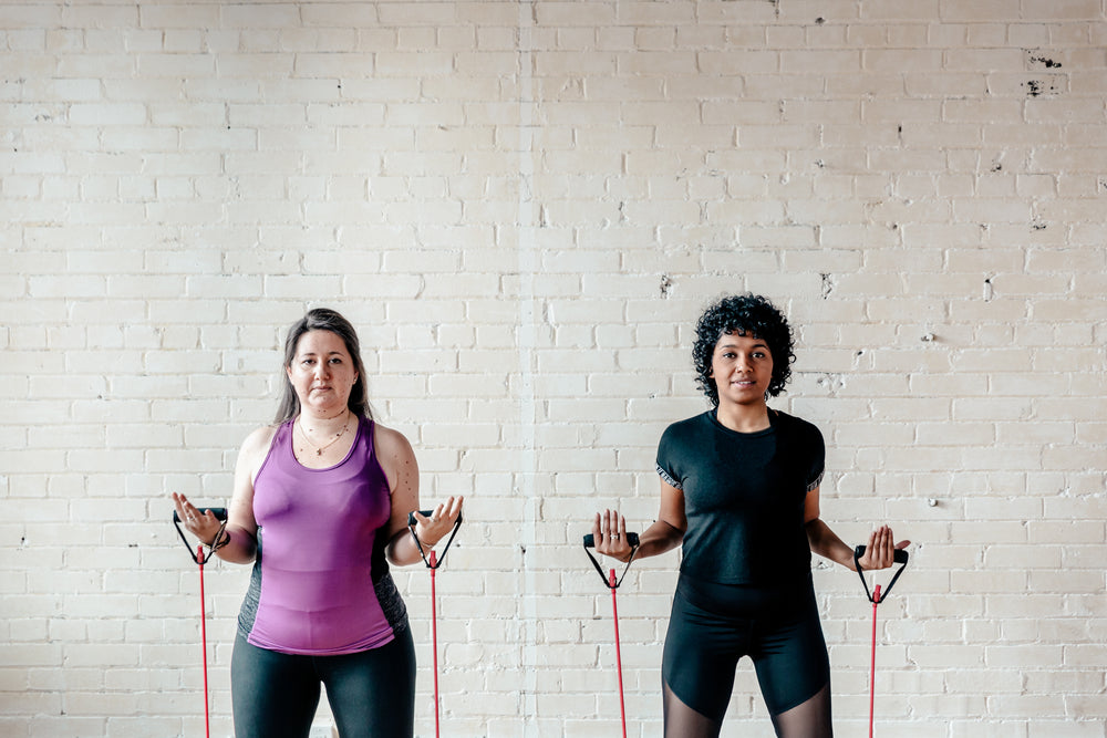 two women with resistance bands