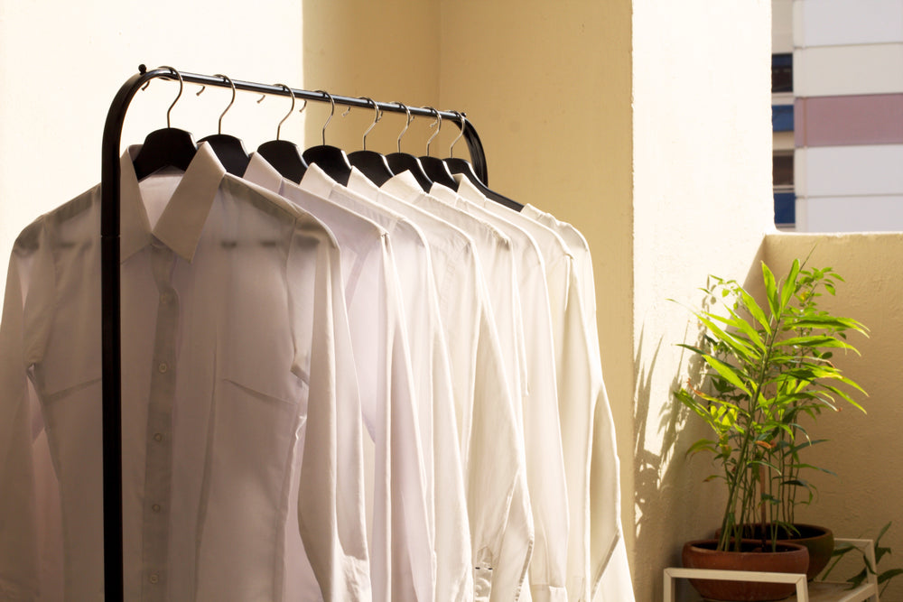 white collar shirts on rack in sun