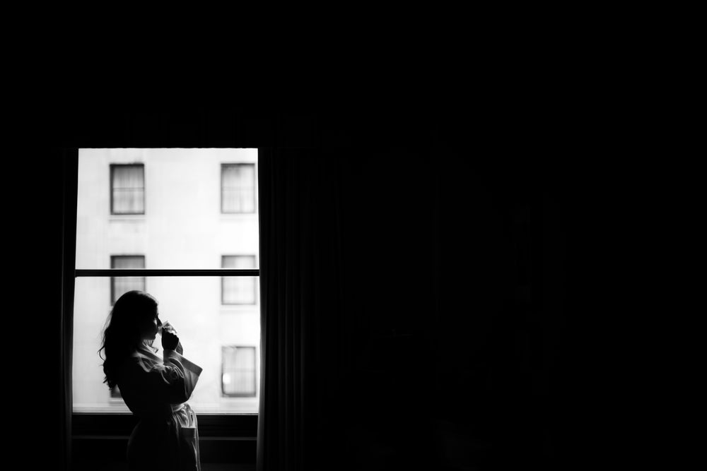 woman at window with morning coffee