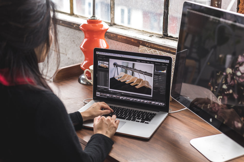 woman edits images on her laptop