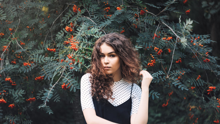 woman in front of tree with berries