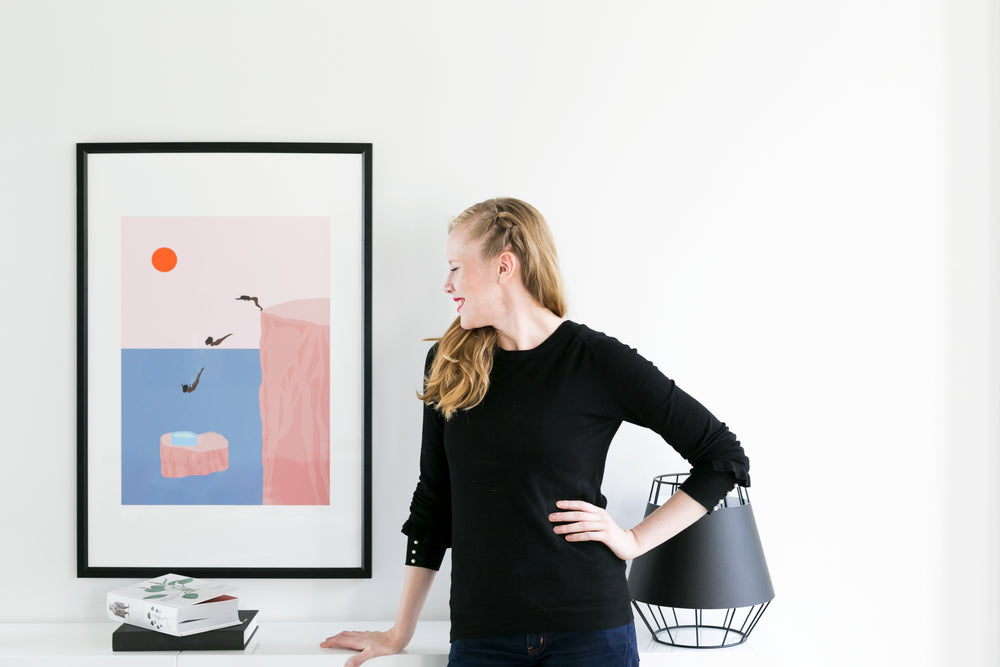 woman leans on desk with books