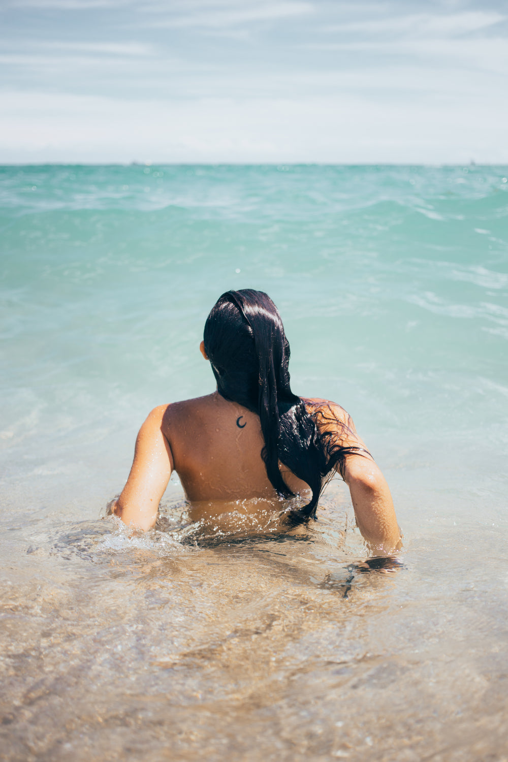 woman swims in ocean