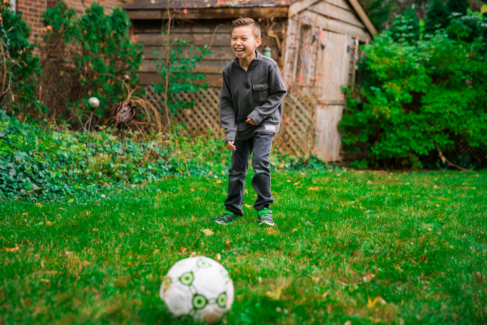 young boy laughing and playing