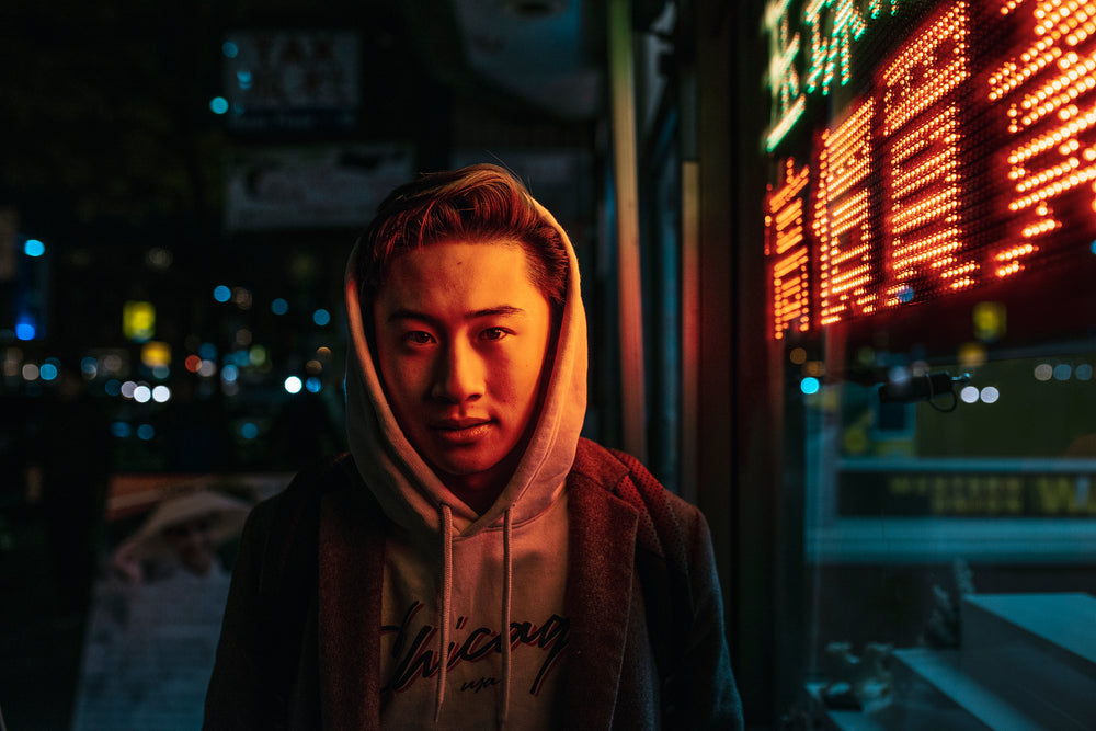 young man stood in front of light