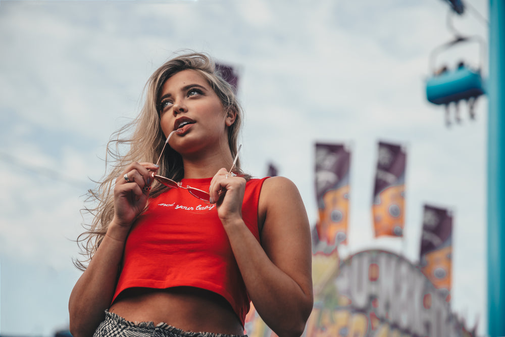 young woman holding sunglasses