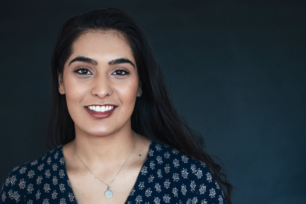 young woman in blue smiling