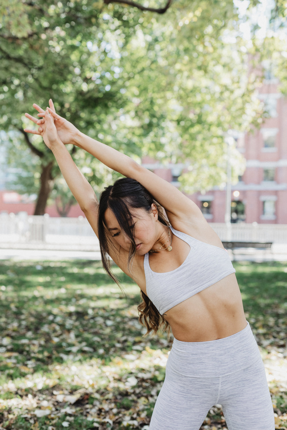 young woman stretching in a park